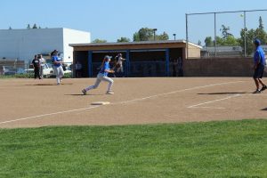 Dahlen Dennis running to catch a live ball at third base.