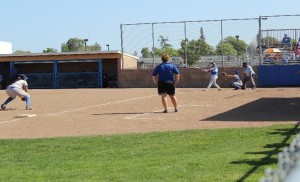 Dahlen Dennis batting while Coach Martin shouts encouragement and watches on.