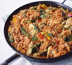 Jollof Rice in the process of being stir fried with chicken. PC: http://www.bbcgoodfood.com/recipes/4750/jollof-rice-with-chicken