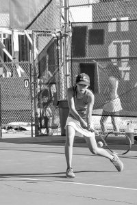 Sophomore Kelly Yoo returns the ball during a home game. (Photo Credit: Jared Tse). 