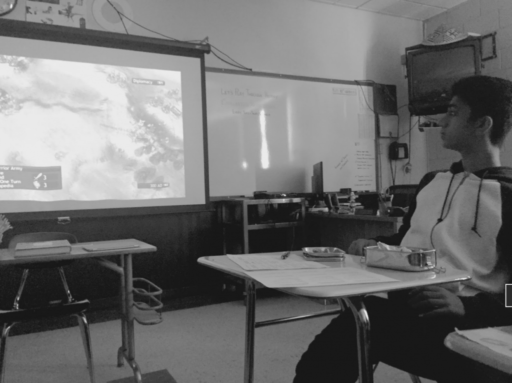 Prateek Ashthana (10) watches as his classmate plays Civilization Revolution on PlayStation 3