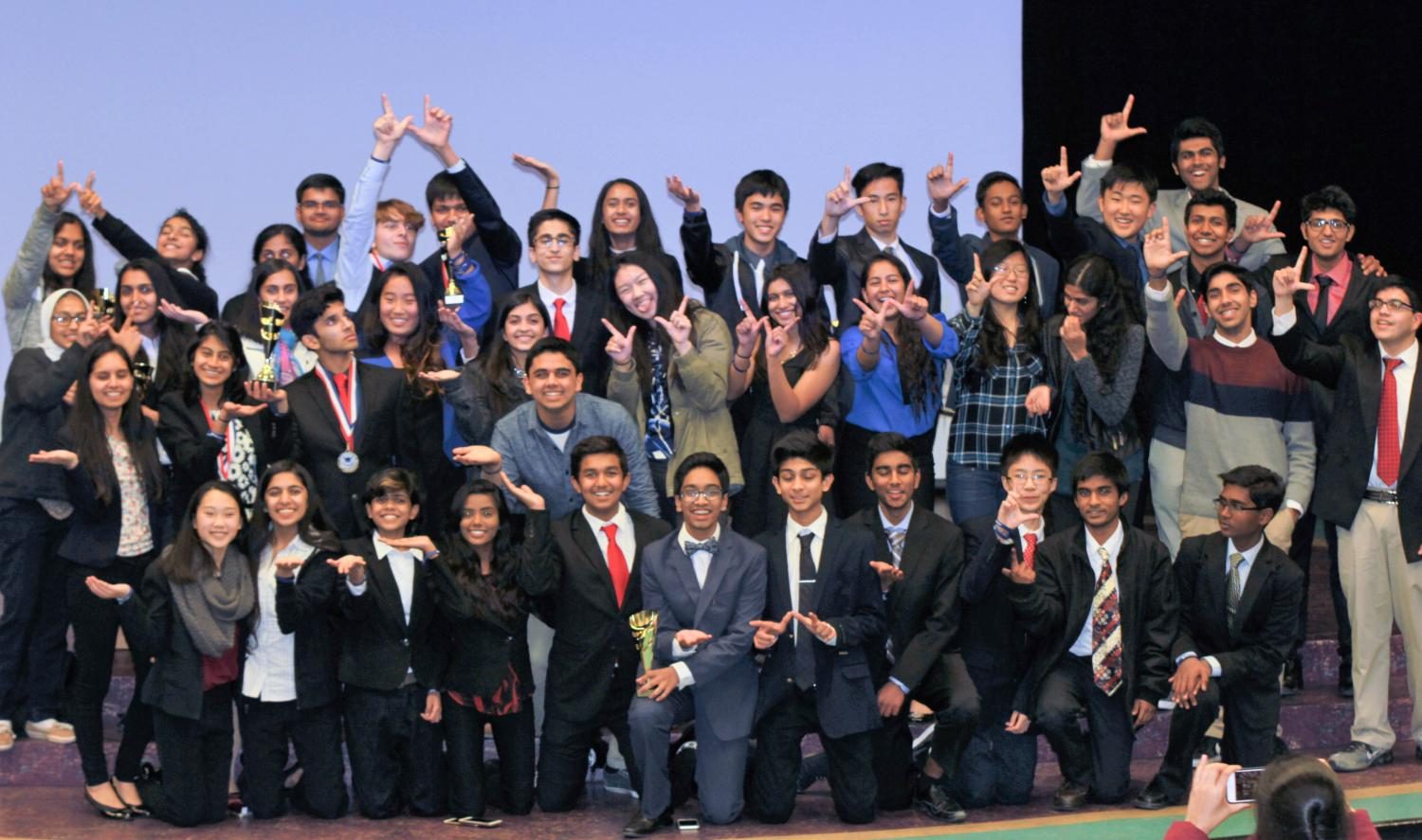 The+Irvington+Debate+Club+rejoices+with+their+trophies+after+the+invitational.