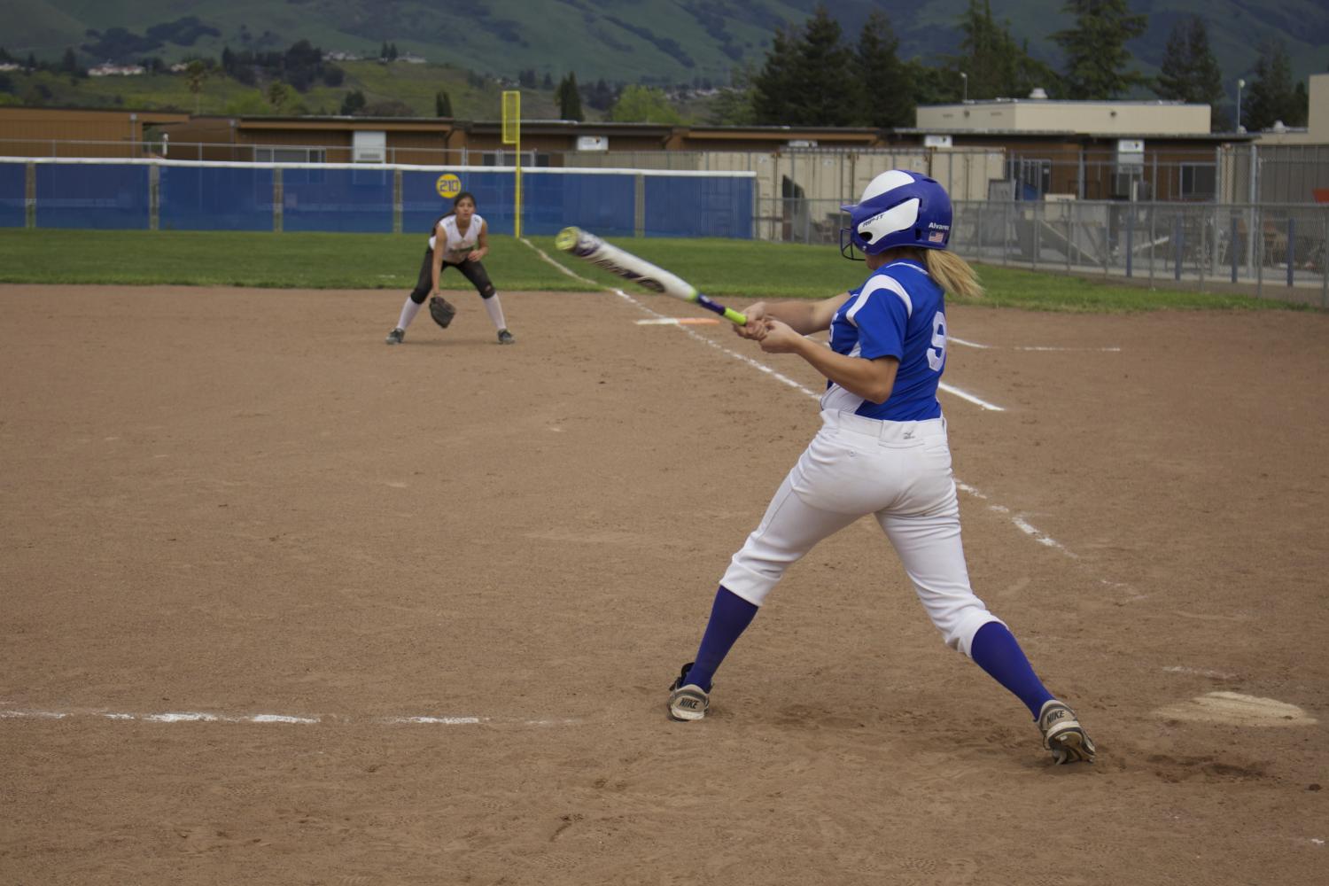 Team captain Annelise Alvarez (12) goes up to bat in the fifth inning and hits the ball, helping Irvington win an extra point.