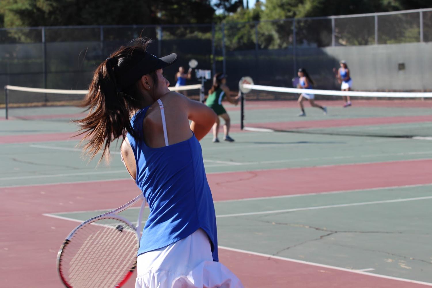Doubles player Shanna Le (10) prepares to return the ball with a double handed backhand shot. 