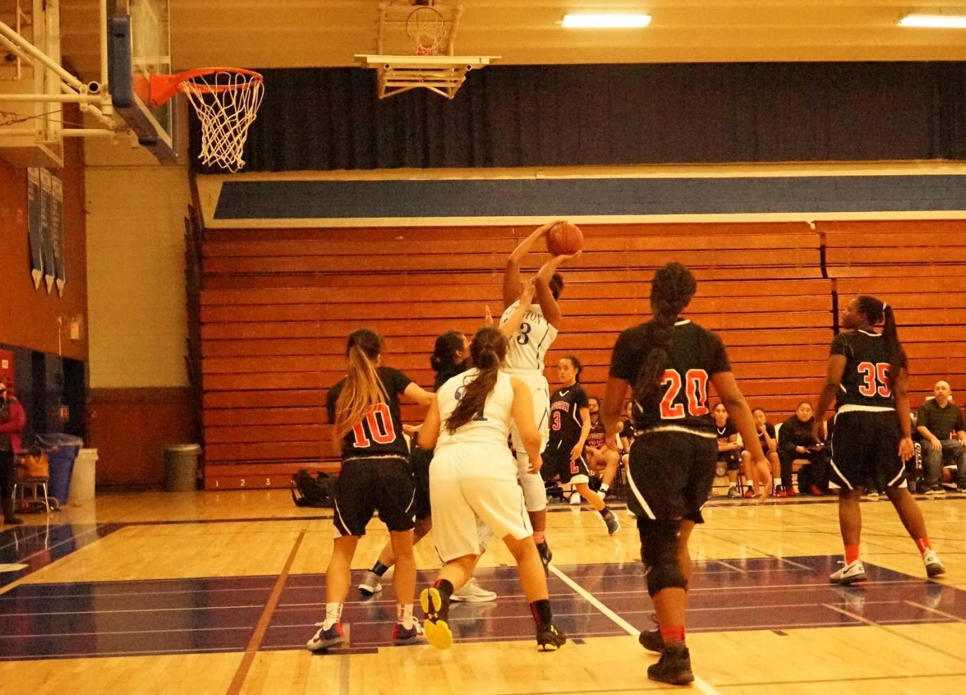 Irvington’s varsity member clutches the ball, ready to score against Logan’s defense