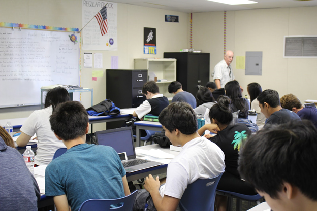 Long term substitute Lyell Walker teaches a senior English class in P16 during third period. 