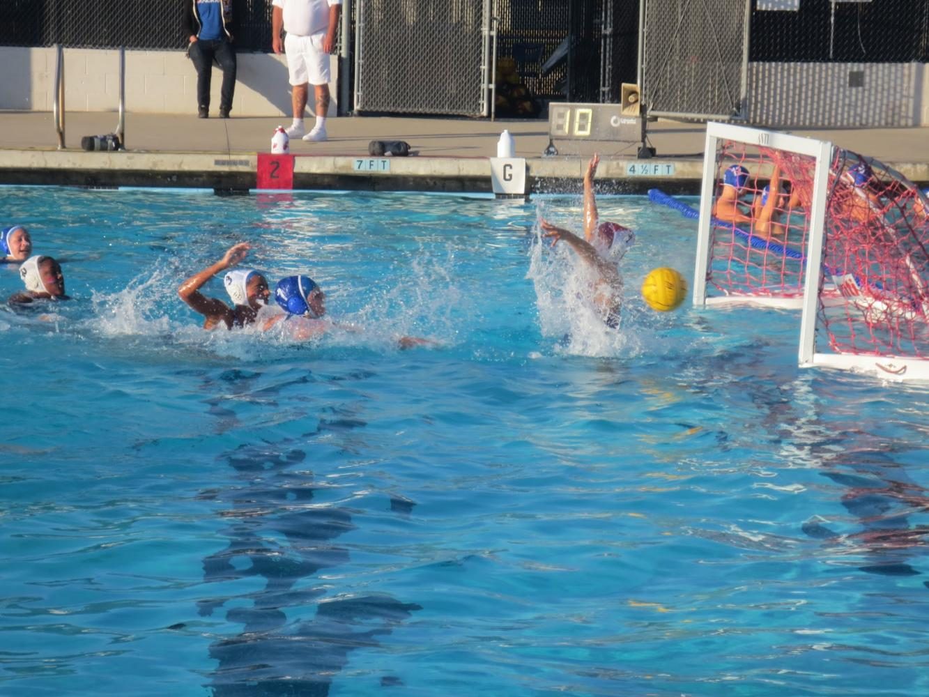 Junior Alexis Gobel scores a goal on American’s goalie. 