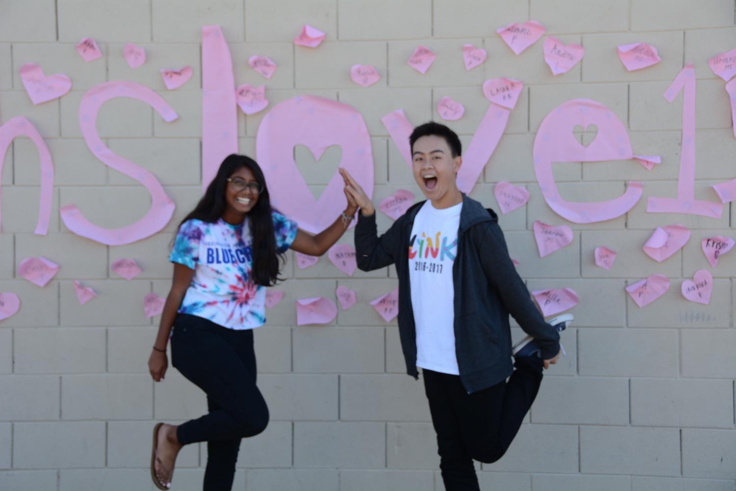 Juniors Sruti Nagam and Derick Nguyen pose in front of the #ihslove16 sign outside of the small gym. (Vivian Hoang)