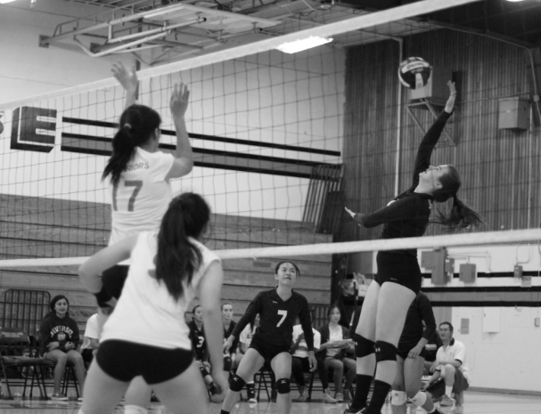 	Freshman Audrey Lee and junior Rachel Walkup set and hit a ball past defending MSJ players in the middle of the second game in the set. (William Yoo) 
