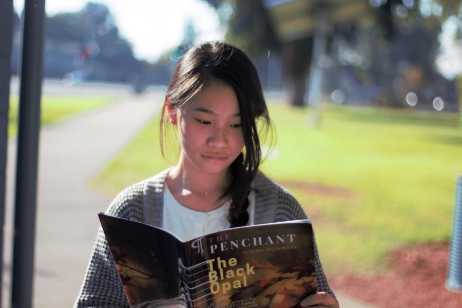 President Lily Yang(11) reads The Black Opal written by Sachi Huilgol, a featured story about how people strive to look good on the outside, despite their inner imperfections. “She understood that flawless beauty such as hers could not be attained without pain. 