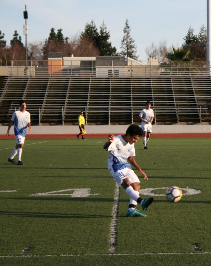 Center-back Rohith Kasar (12), part of the team’s defense, makes a pass via a high kick. 