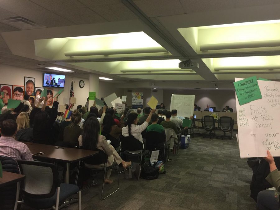 In the school board meeting on April 18, supporters of the policy wore green while people who were against the policy wore white. Parents and staff on both sides came up to voice their opinions about the program and created posters and signs to demonstrate their beliefs.