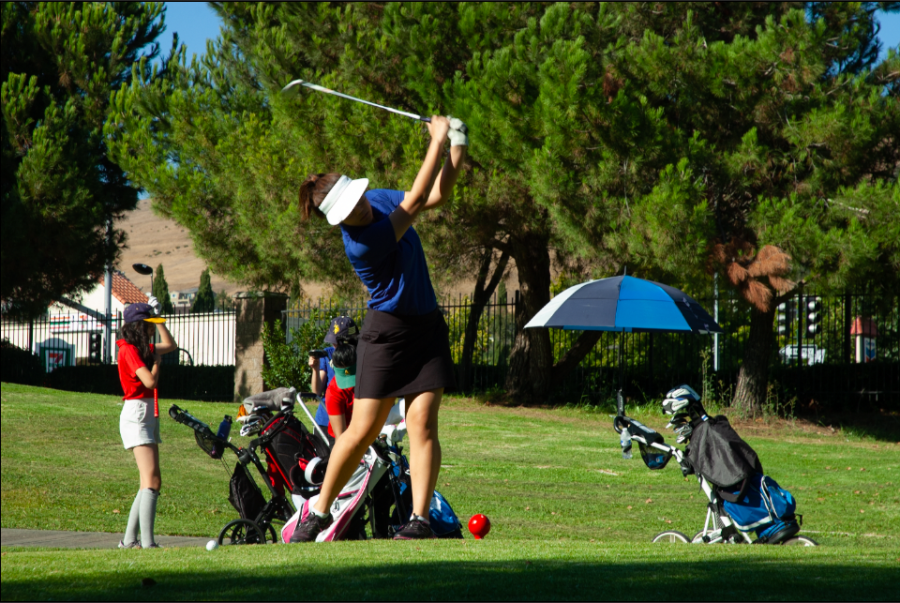 Phoebe Lai (10) prepares to tee off at a shot. 