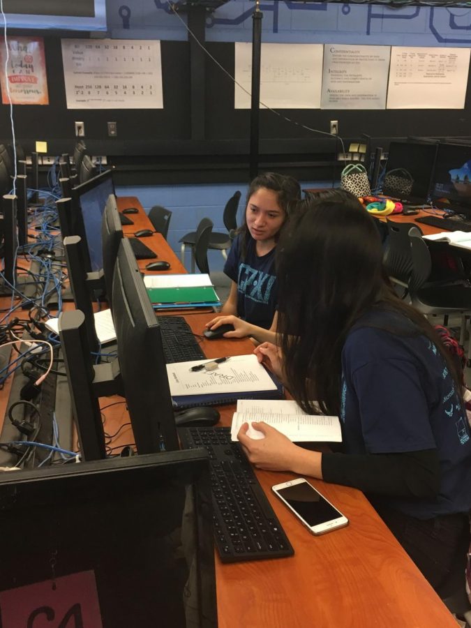 Samantha Bustamante (12) and other members of the girls’ teams practicing for the competition at a computer. 
