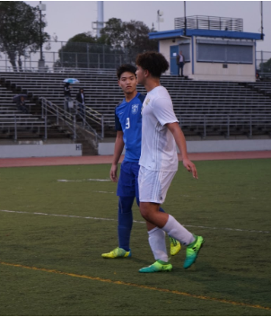 Seungwoo Lee (12) prepares to defend his man.