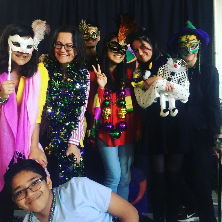 From left to right: Amadine Vardhan, Mme Cayla, Neil Karkhanis, Nicole Huynh, Jessica Mason, Jack Merrell, and Ronit Gupta pose at the Mardi Gras photo booth. 