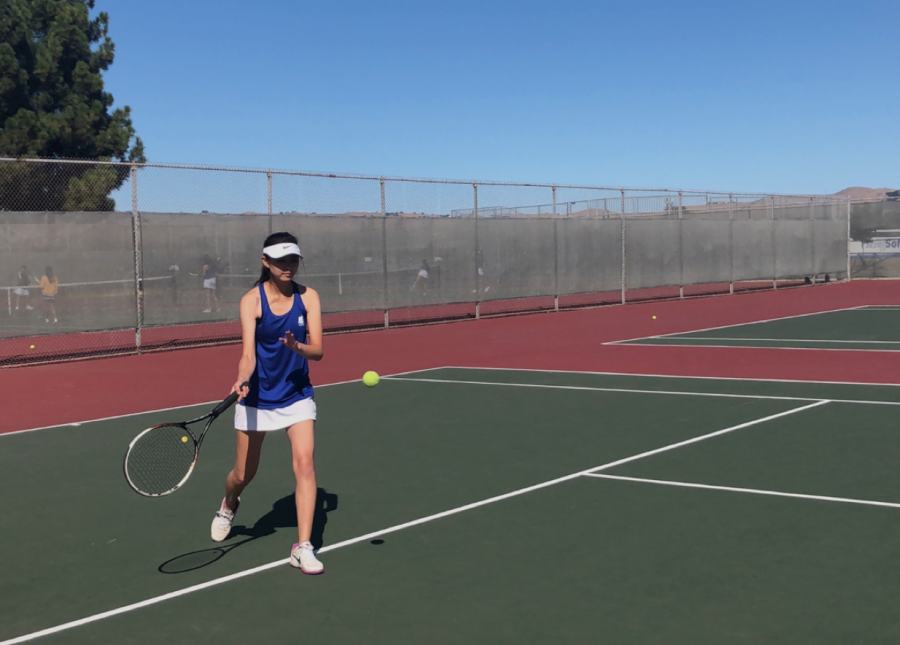 Charisse Hao (11) returns a pass from her opponent. 