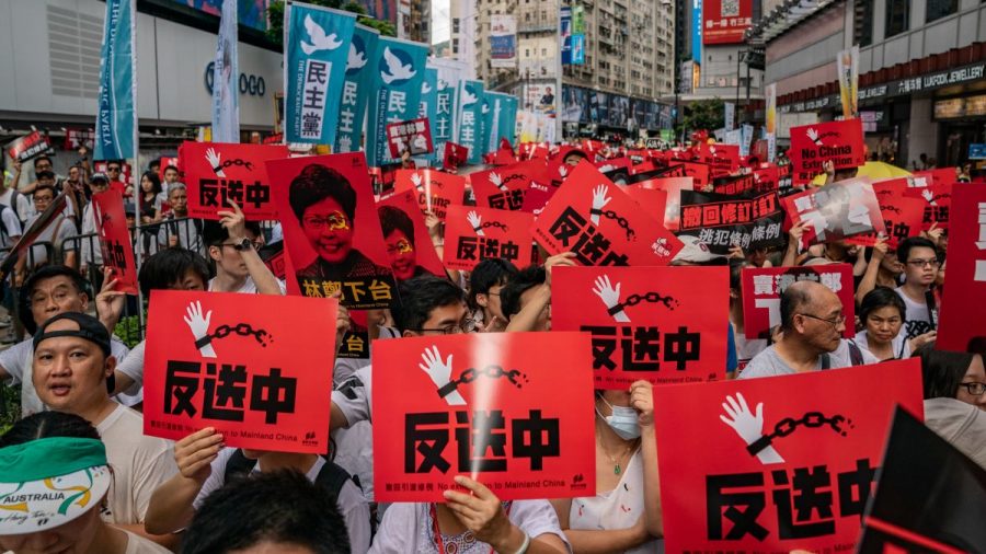 Hong Kongers can be seen protesting against an extradition bill that will require Hong Kong prisoners to hold trial in mainland China
