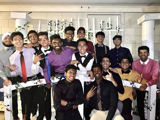 Class of 2020 boys pose in front of the bridge and backdrop decorations at Irvingtons 2019 homecoming dance.