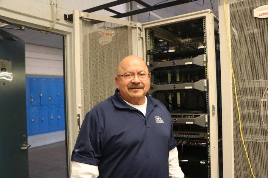 Mr. Albizo, who has been teaching courses related to internet engineering at Irvington for ten years, poses in front of various routers and switches, which are essential to running networks.