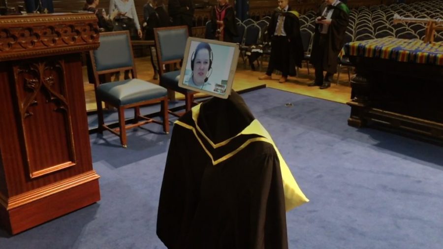 Picture Credit: BBC News: Above is a picture of a distant education graduate; the Irvington Voice correspondent could not get a proper picture due to the blurry nature of the livestream, but has been provided this by the Irvington administration as a valid depiction of the ceremony and its intentions. 
