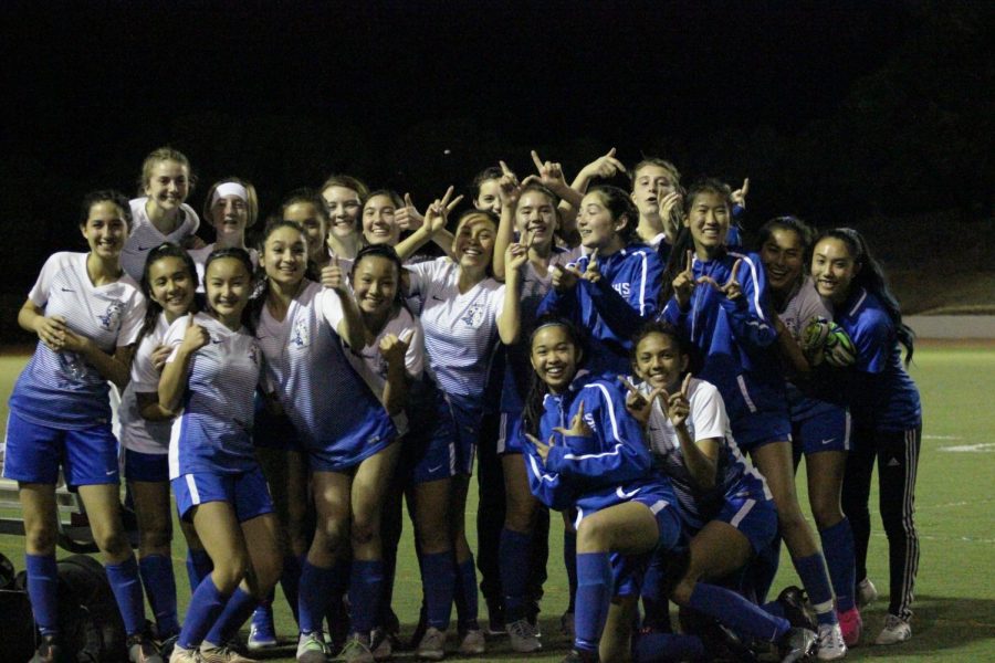 The 2019-2020 Varsity Girls Soccer team shows the close bond between the upperclassmen and the underclassmen, with both groups smiling at the end of a successful season.