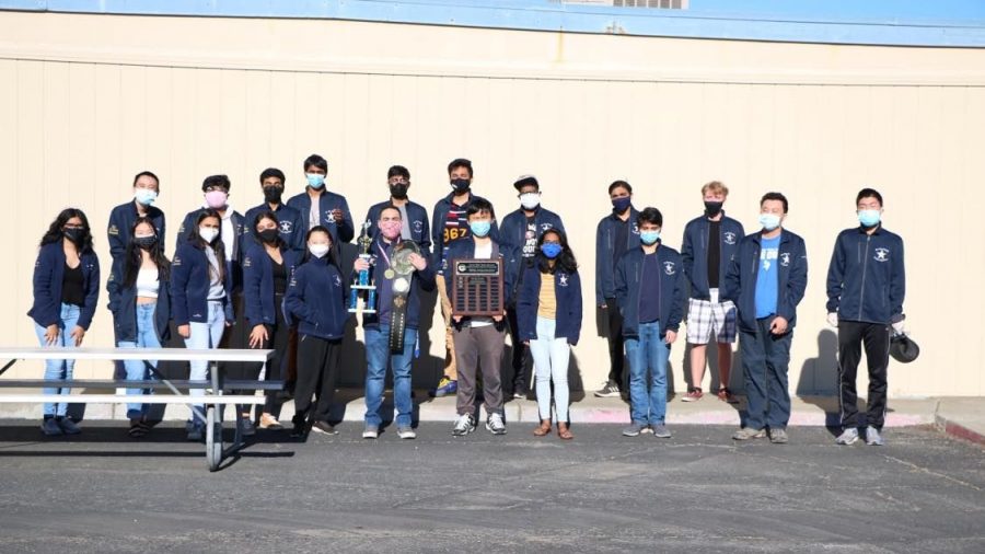  Irvington’s We The People team, including coach Mr. Martinez, poses with their trophies.