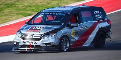 A minivan looks to set a lap record on a F1 track