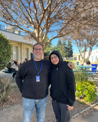 Above Mr. Pearce is pictured with one of his students. 