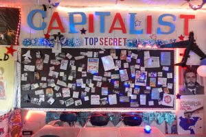Students from the capitalist faction in Mr. V’s class create a clues board by connecting capitalist posters, documents, and portraits