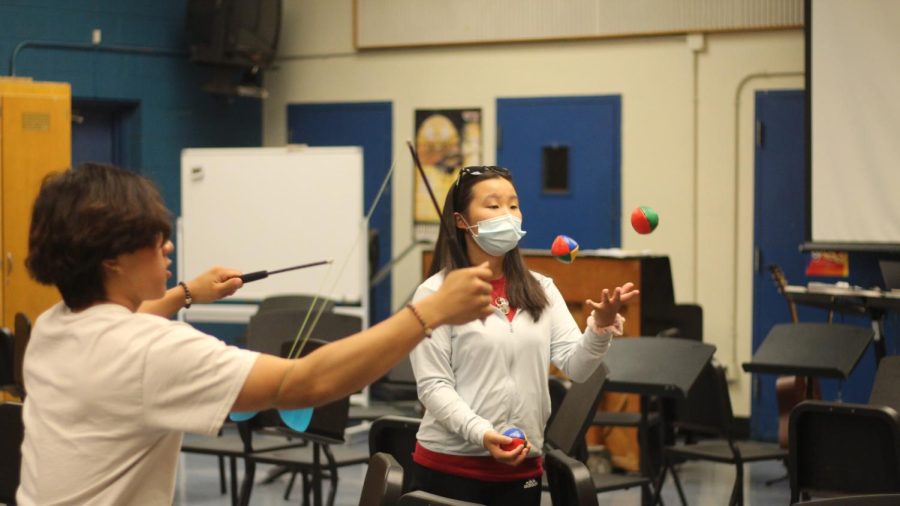 From left to right, Tristian Xu (12) and Juggling Club president Eileen Chao (11) practice juggling with various objects.