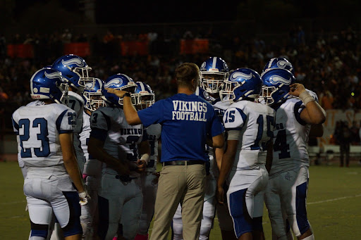 Vikings Football huddles up at timeout during the game against the Washington Huskies.