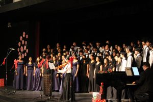 The combined choirs sing “Crowded Table,” with Sandee Liu (11) on the violin, to start off the winter concert session.