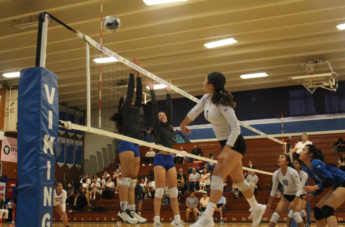 Isabelle Wu (11) hits back a ball to the Newark team.