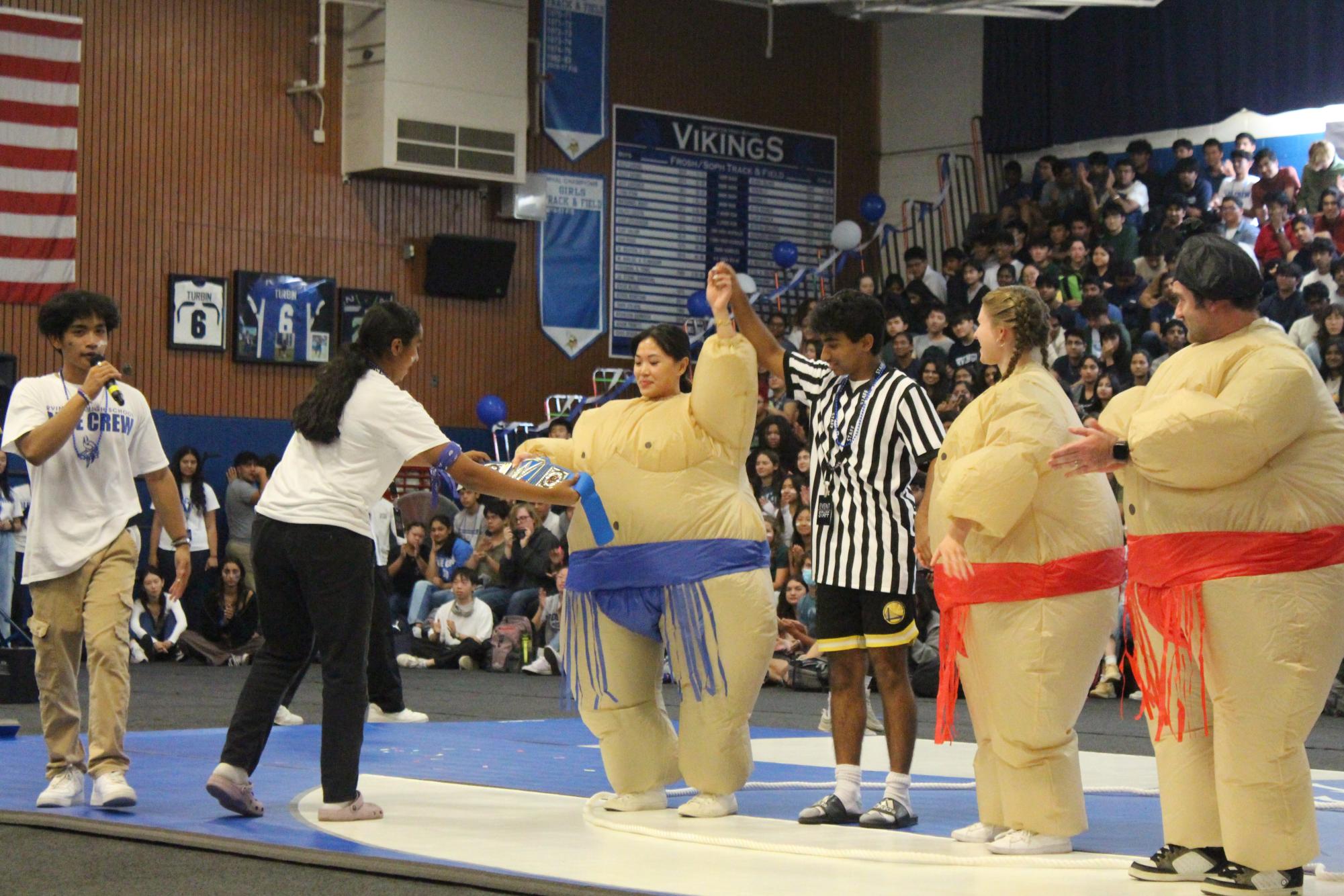 Mrs. Jessica Lee celebrates her win against Ms. Ariela Koehler after their sumo wrestling fight. 