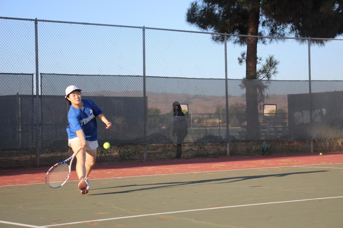 Varsity captain Jolene Wei (12) competes in the last varsity match on senior night, securing the victory for Irvington.