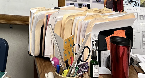 Ms. Hallford’s curriculum and to-grade papers sorted by period on her desk 