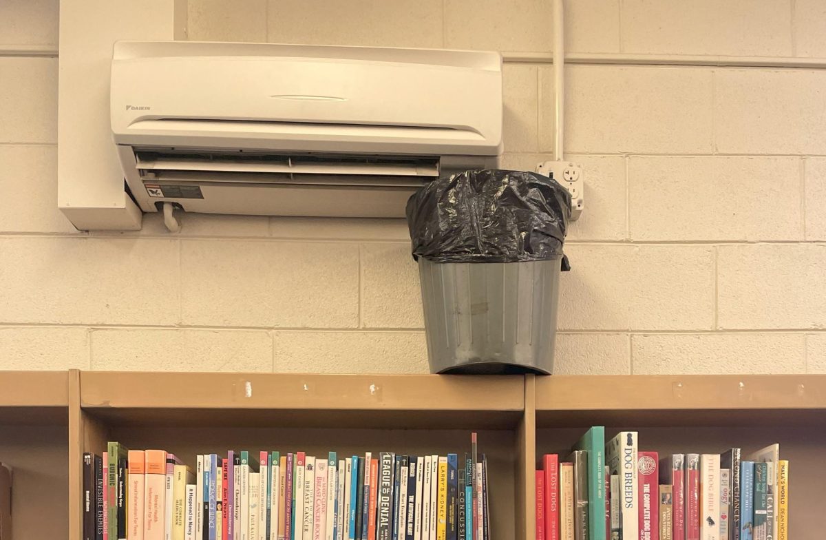 Trash can collects water leakage from AC unit in the library