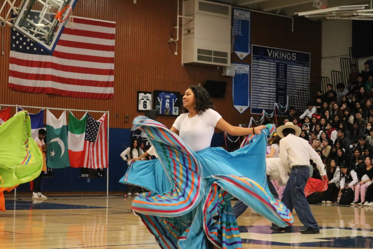 MEChA performs in the Multicultural rally with dancers imitating a Spanish bull fight.
