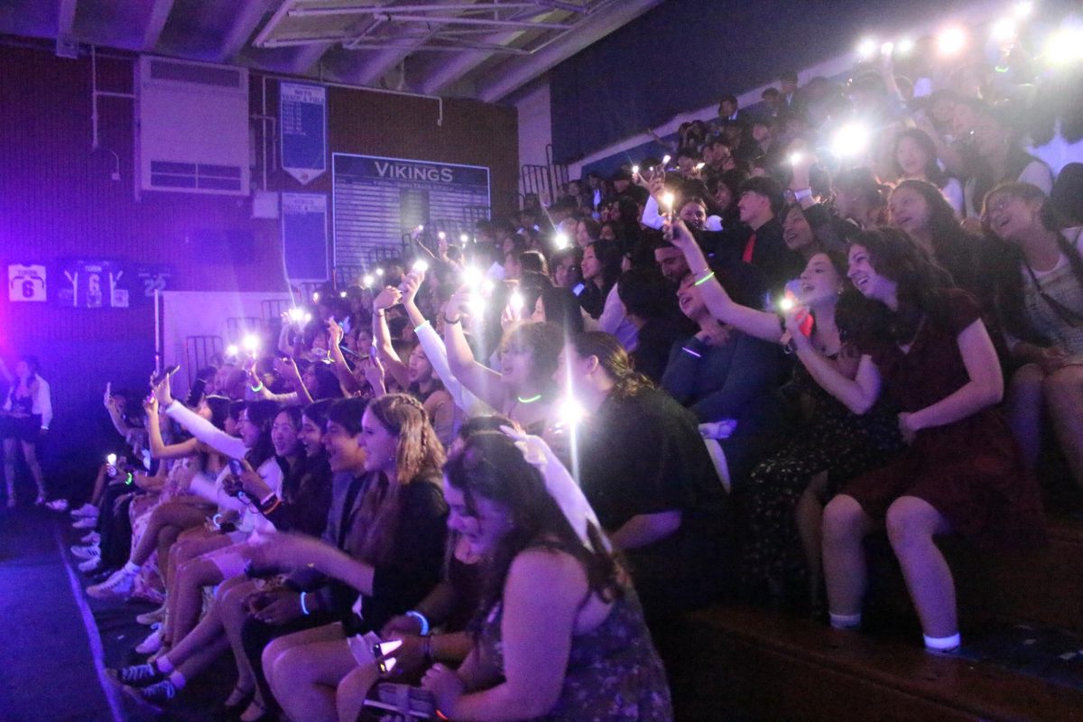 Audience+members+at+the+Blacklight+Rally+wave+their+cell+phone+flashlights+during+a+Finish+the+Lyrics+contest.