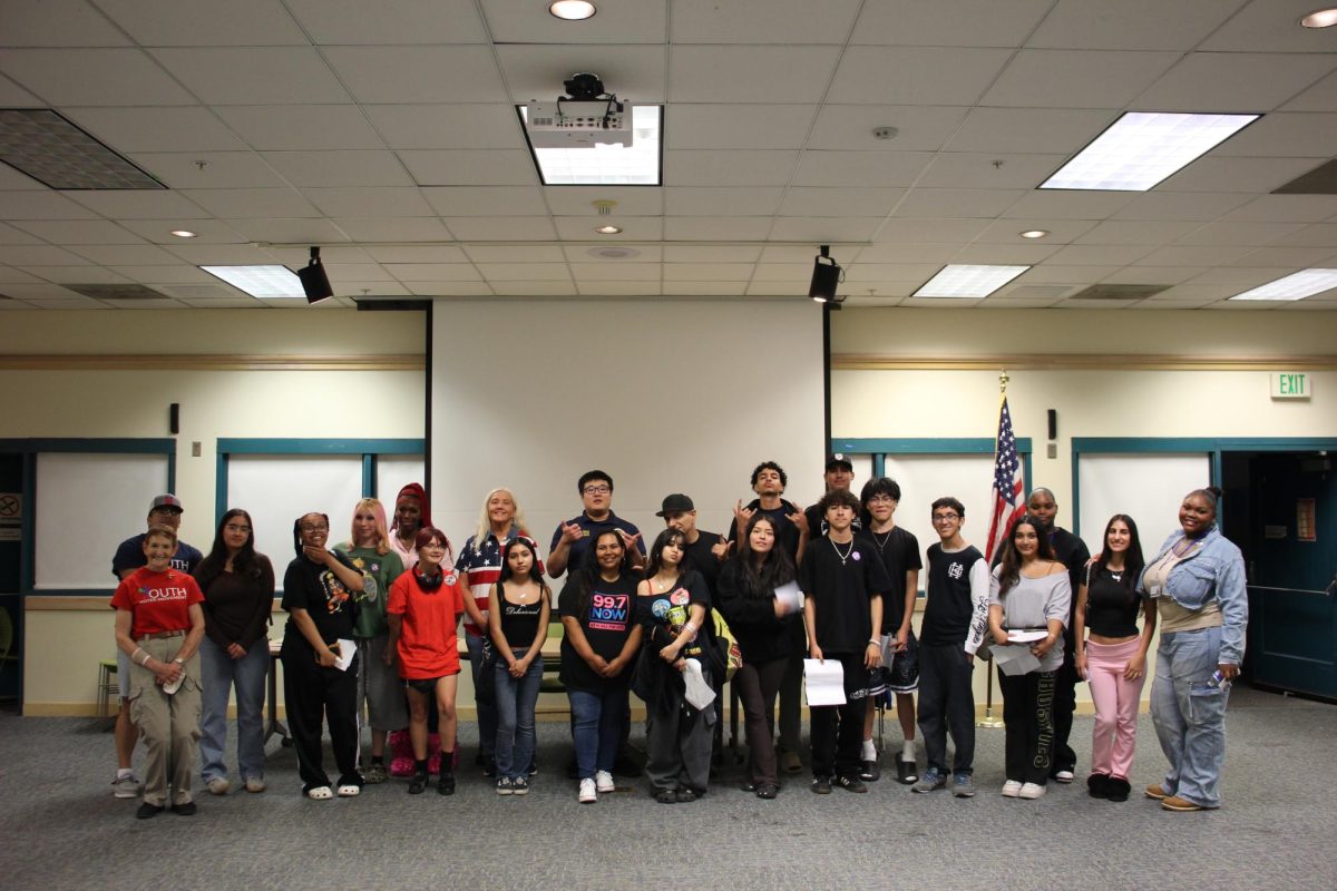 Watch party attendees pose for a picture after the discussion, having learned much more about politics and each other.