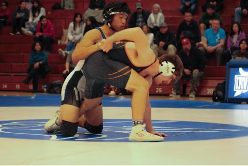 Irvington wrestler attempts to submit his opponent from Washington.
