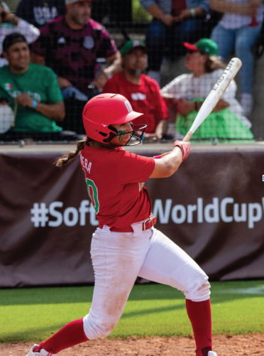 Vera bats while playing for Mexico’s national women’s team( World Softball Baseball Confederation Photographers).