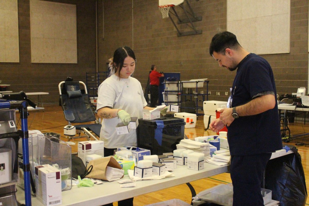 SBC phlebotomists tidy up the donation site workspace after the blood drive. 