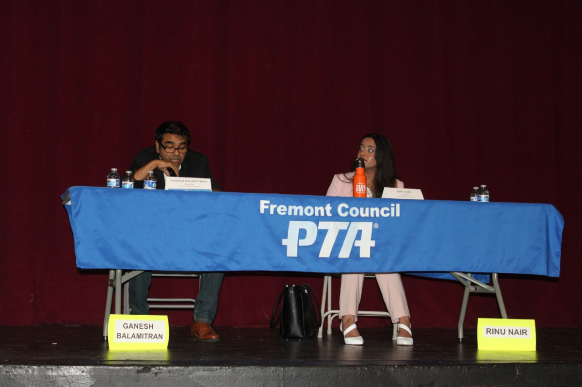 Candidate Ganesh Balamitran (left) answering a question during the forum, candidate Rinu Nair (right) pictured sitting next to him.