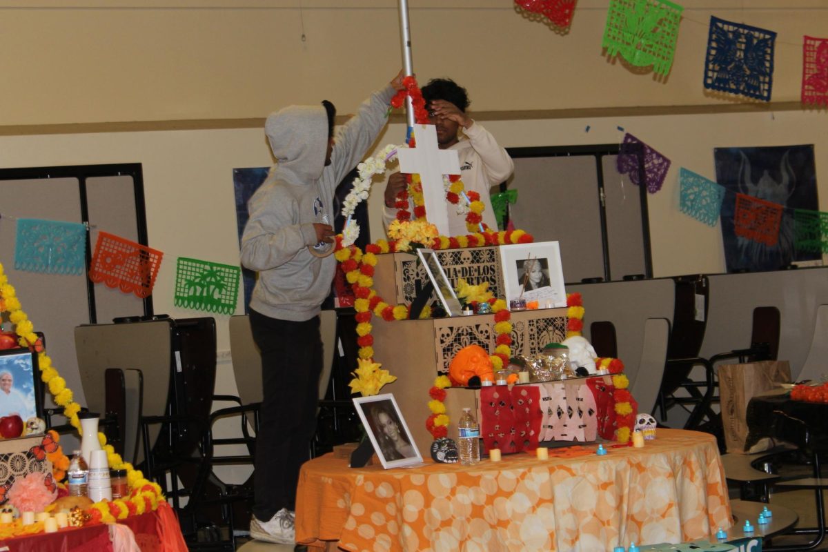 Spanish 4 students set up ofrendas in the cafeteria on Friday morning.