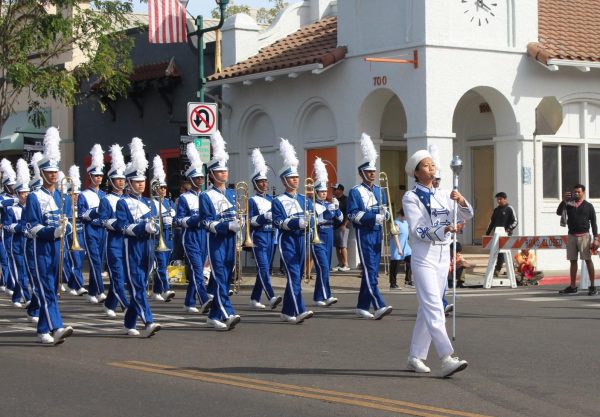 The Varsity marching band marches down Main Street for their parade competition.