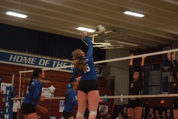 Alaina Schuman (12) hits back a ball to the Kennedy team. 