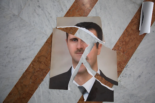 A torn picture of Bashir al-Assad, former dictator of Syria, symbolizes his removal of power. NCPR News.
