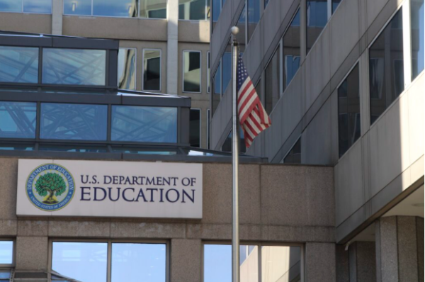 Caption: The American flag waves outside the Department of Education Building in DC
Image Credit: EdSource
